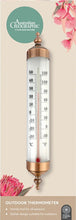 Load image into Gallery viewer, Outdoor thermometer with decorative copper top on a beige background with floral elements.