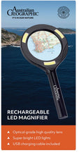 Load image into Gallery viewer, An Australian Geographic branded rechargeable LED magnifier shown over a coastal ocean background, with product text and features listed below.