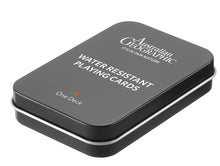 Load image into Gallery viewer, Black tin box with 'Australian Geographic' branding and text about water-resistant playing cards on a white background.