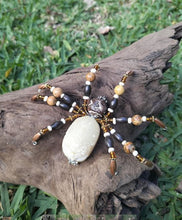 Load image into Gallery viewer, Decorative spider made of beads and stone on a wooden log with grass background
